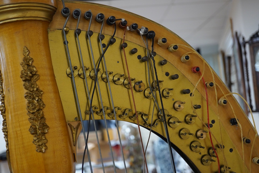 A Grecian satinwood seven pedal harp by J.C. Schwieso & Co., 19 Great Marlborough Street, Regent Street, London, numbered ‘824’, with brass makers plate and decorated with gilt mouldings, 173cm high